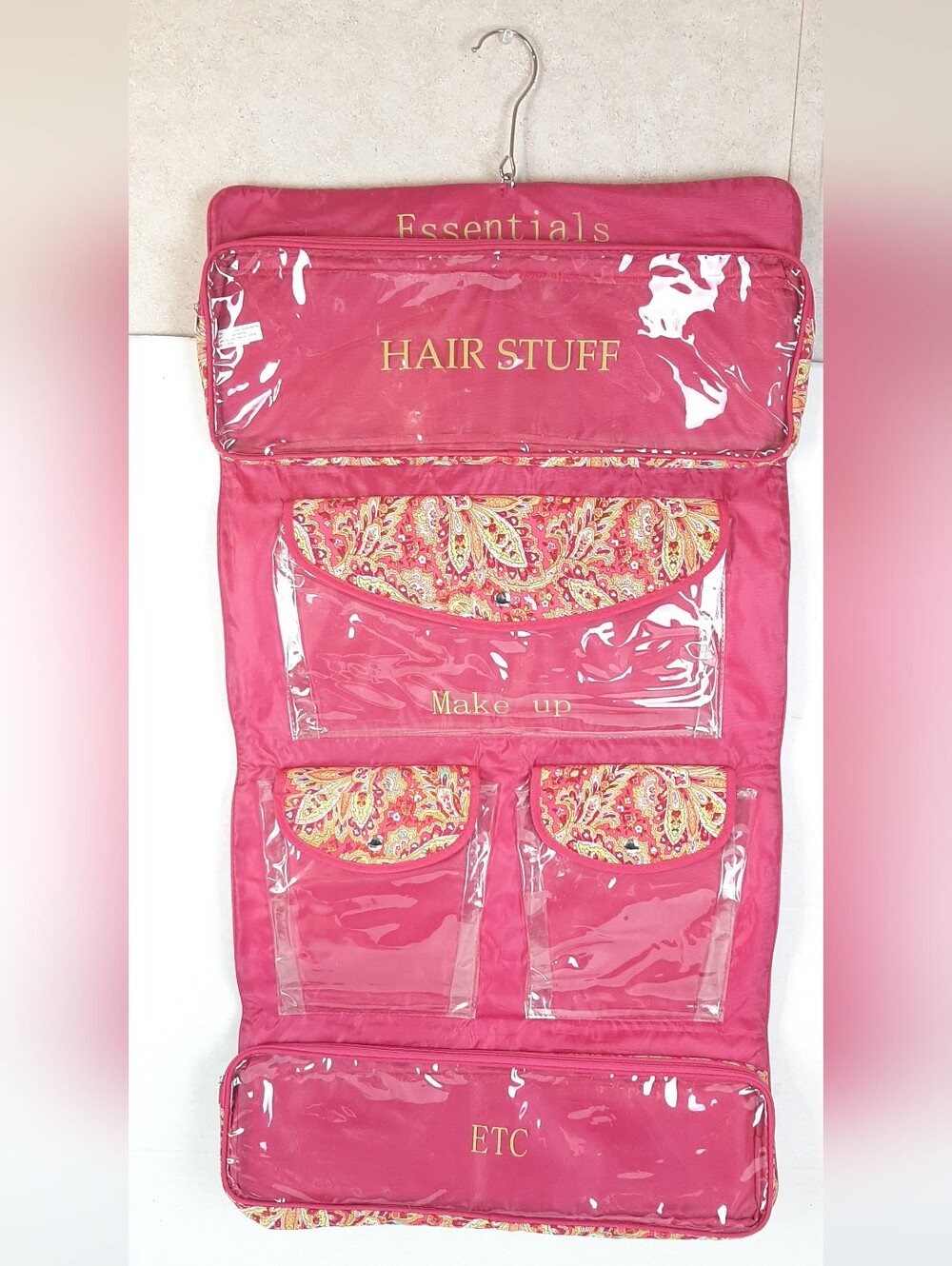 Pink paisley print hanging cosmetic and travel organizer bag with labels